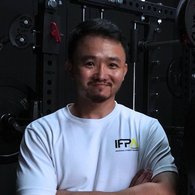 Brian Chang, founder of Carbyne Education, at the gym in an IFPA Personal Fitness Trainer shirt
